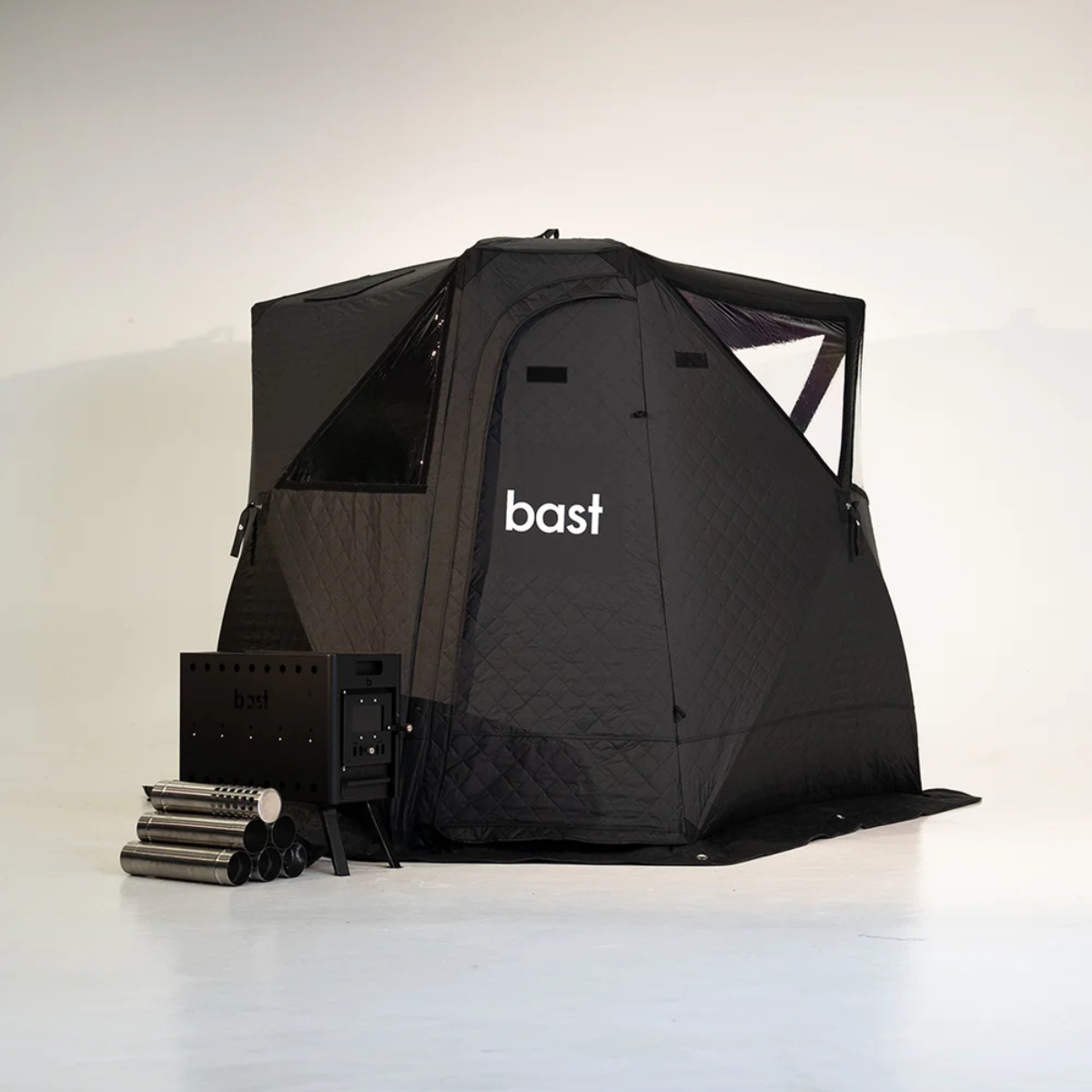 Black pop-up sauna tent kit showing tent, stove, and accessories included in the basic kit.