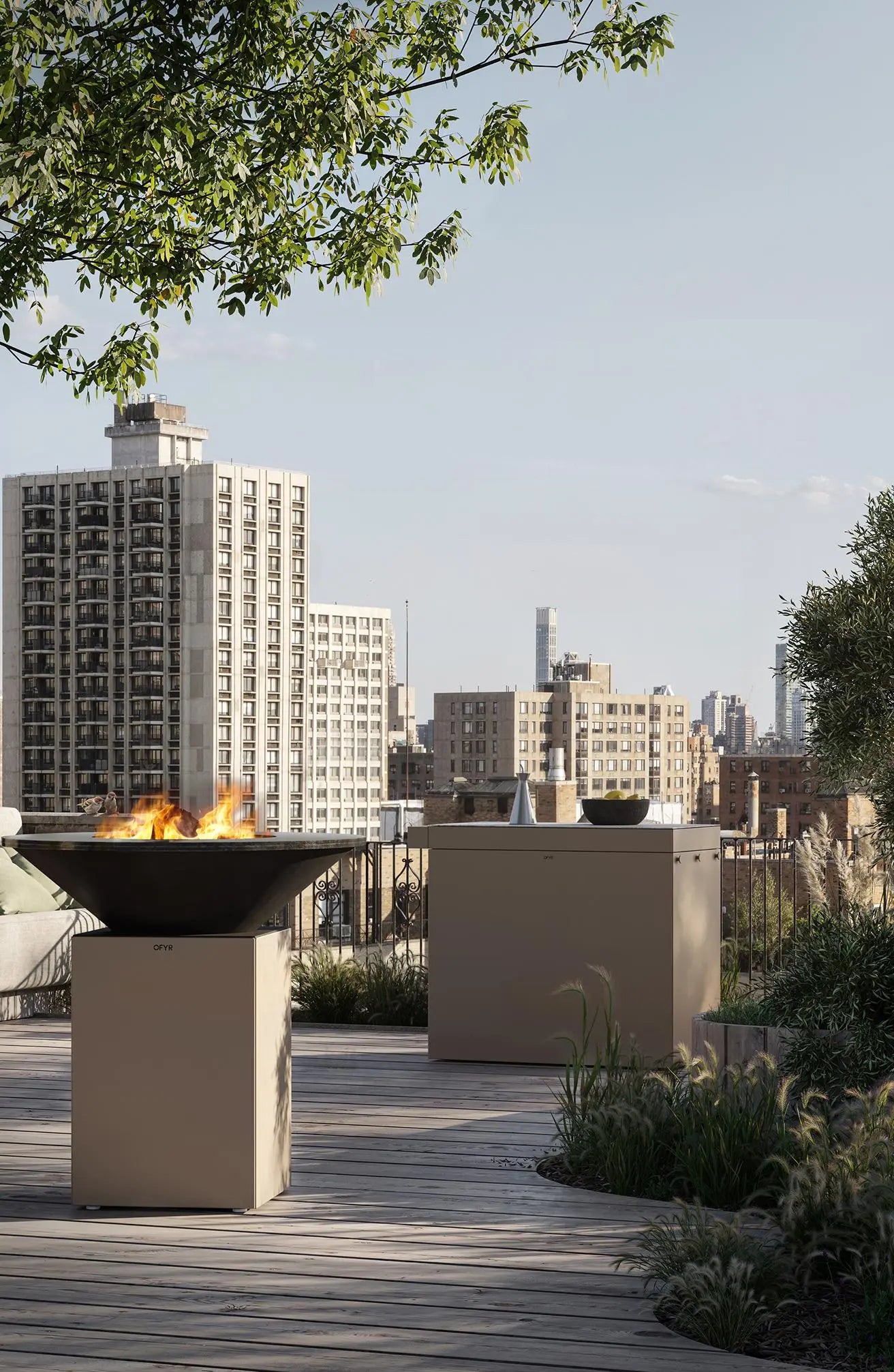 OFYR fire grill on a rooftop with city skyline in the background