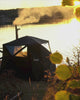 Bast outdoor sauna tent by lake in autumn